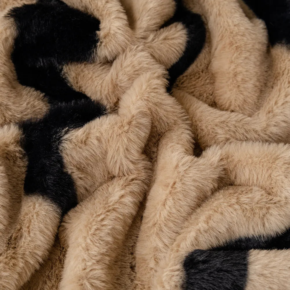 Zebra pattern flannel sofa cover in a caramel colour, shown draped over a sofa.