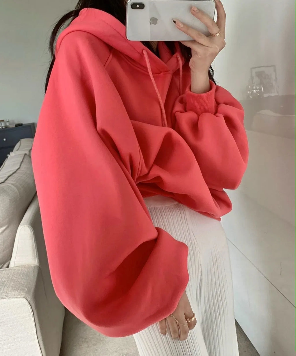 Women's watermelon red sleeveless hooded sweater made from mulberry silk fabric on a hanger