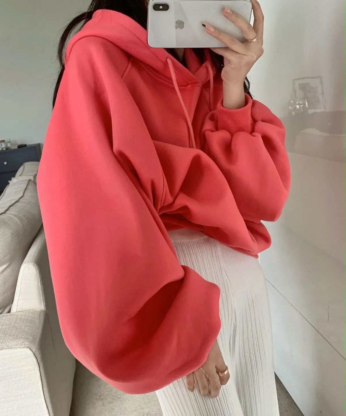Women's watermelon red sleeveless hooded sweater made from mulberry silk fabric on a hanger