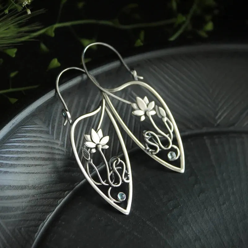 Silver rhinestone earrings with geometric lotus vine design on alloy base