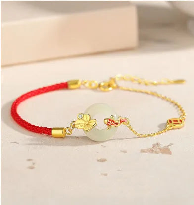 Gold electroplated 925 sterling silver bracelet with red rope and peace buckle featuring koi fish design