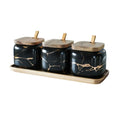 Nordic gold marble ceramic jar set with wooden tray and bamboo spoon on a kitchen counter