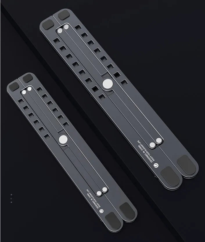Portable aluminium laptop stand folded flat next to an open laptop showing its adjustable height.
