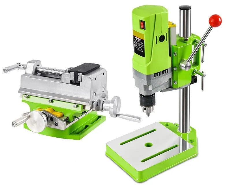 Bench-mounted drilling and milling machine with motor, chuck, and adjustable work table.