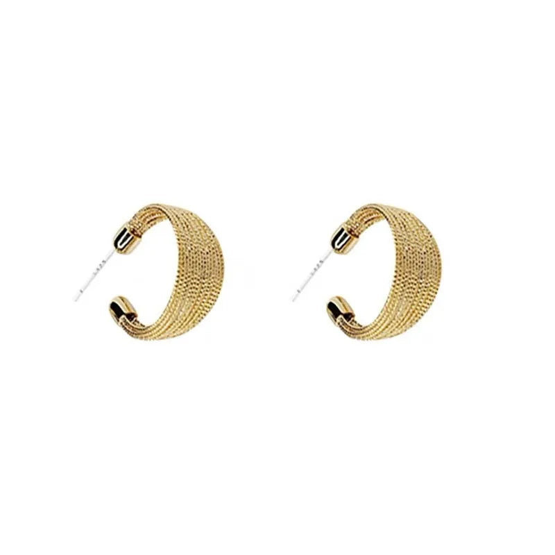 Set of geometric multi-layer earrings in gold and silver, showing stud and clip styles on a flat surface.