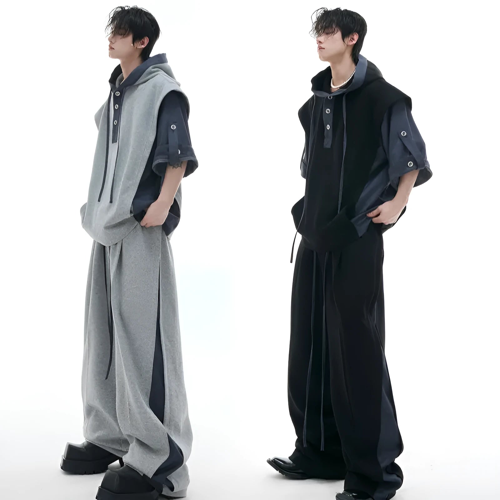 Men's black hooded short sleeve polyester sports suit with textured stitching and matching trousers on a grey background.