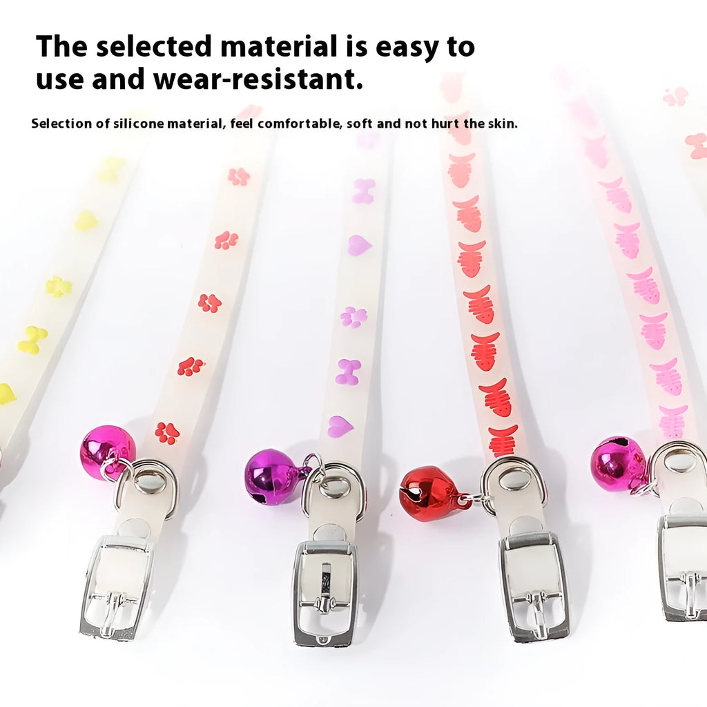 Glow in the dark adjustable silicone cat collar with metal bell in paw print pattern.