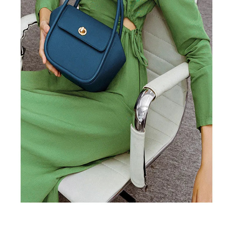 Genuine cow leather wing-shaped tote bag with buckle detail and cross-body shoulder strap