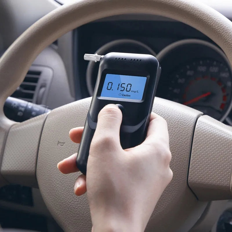 Black household alcohol tester with digital display for breath checking