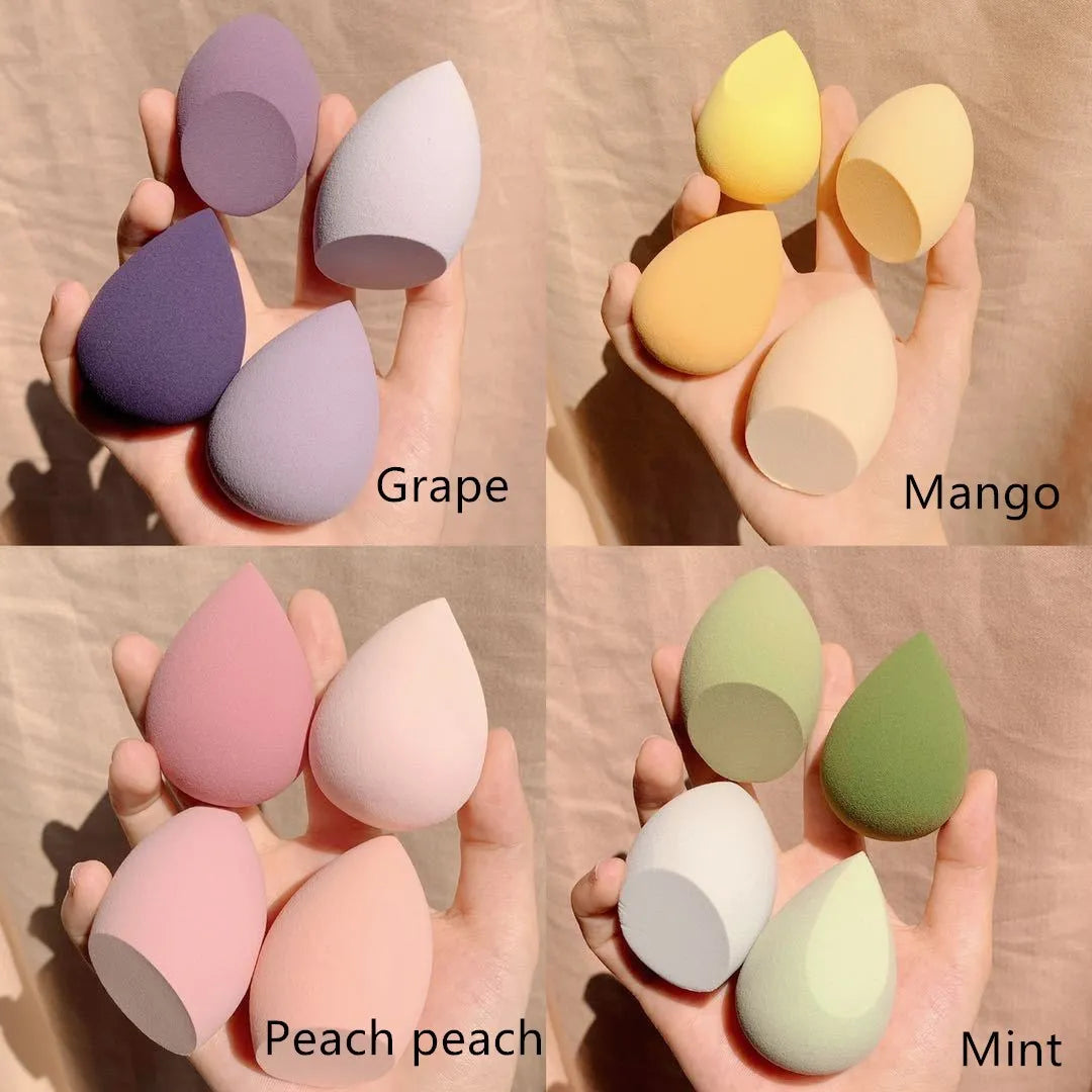 Makeup egg box open showing four coloured synthetic sponge beauty eggs in grape, mango, mint and peach peach.