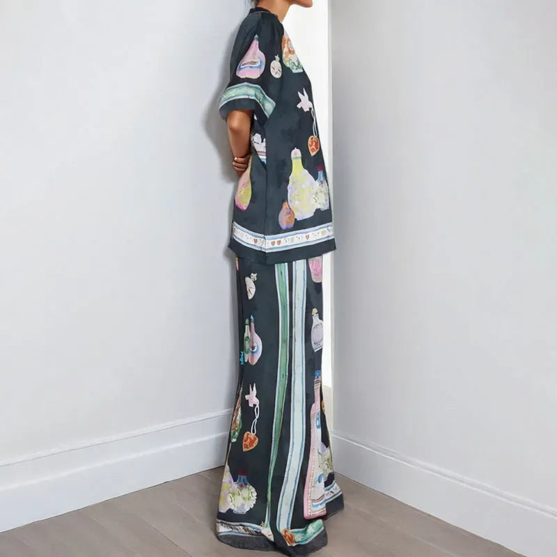 Black women's casual set with cartoon print, featuring a cardigan and matching trousers.
