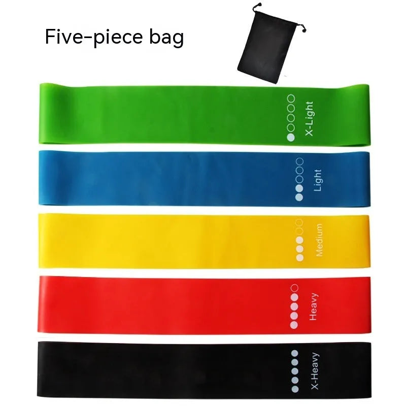 Set of five coloured TPE yoga tension straps for fitness training laid flat showing green, blue, yellow, red, and black.