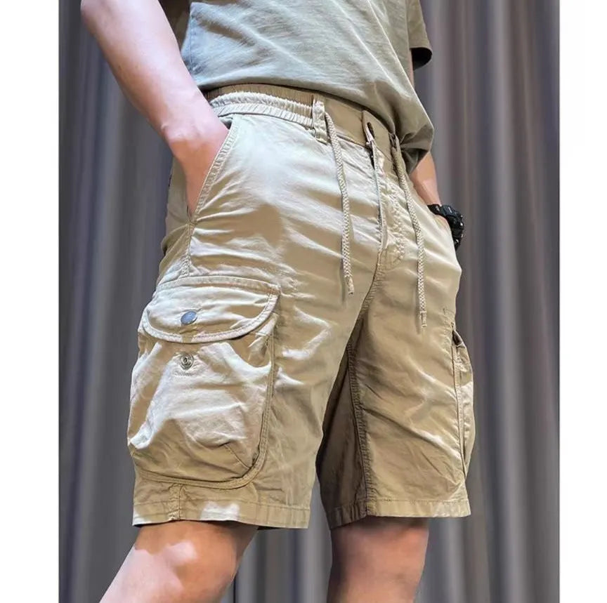 Loose straight-leg overalls pants in khaki with multiple cargo pockets on the legs.