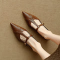 Brown women's cowhide leather flat shoes with round toe and metal detail on a soft sole.