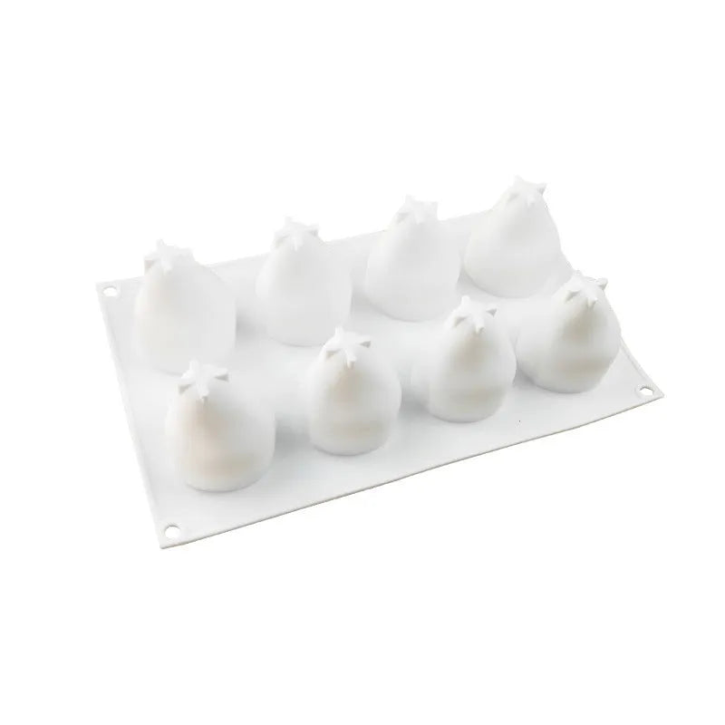 Set of six flexible silicone baking moulds shaped like pears, pineapples, and pine cones.