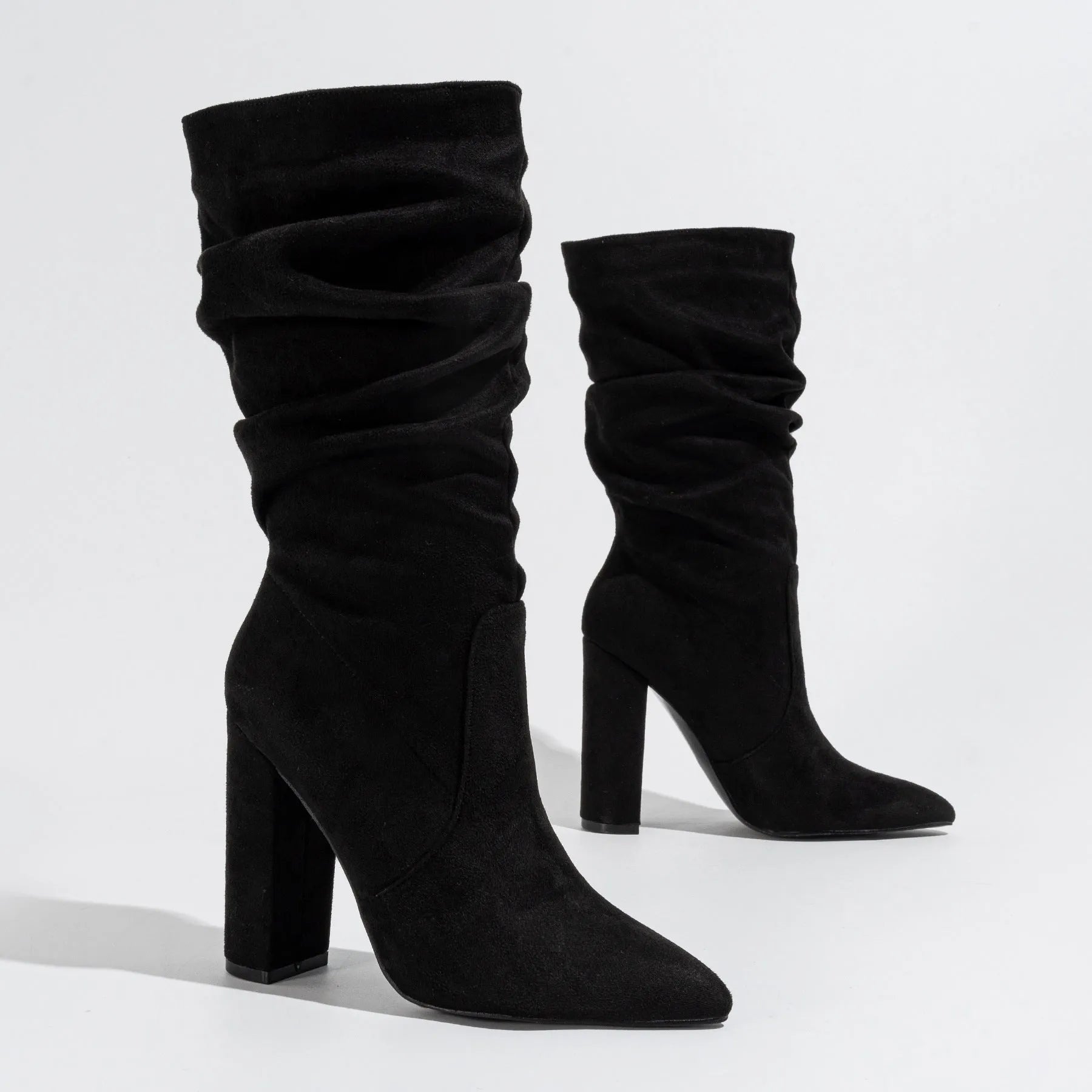 Women's black suede chunky heel boots with a pointed toe and middle-calf shaft.