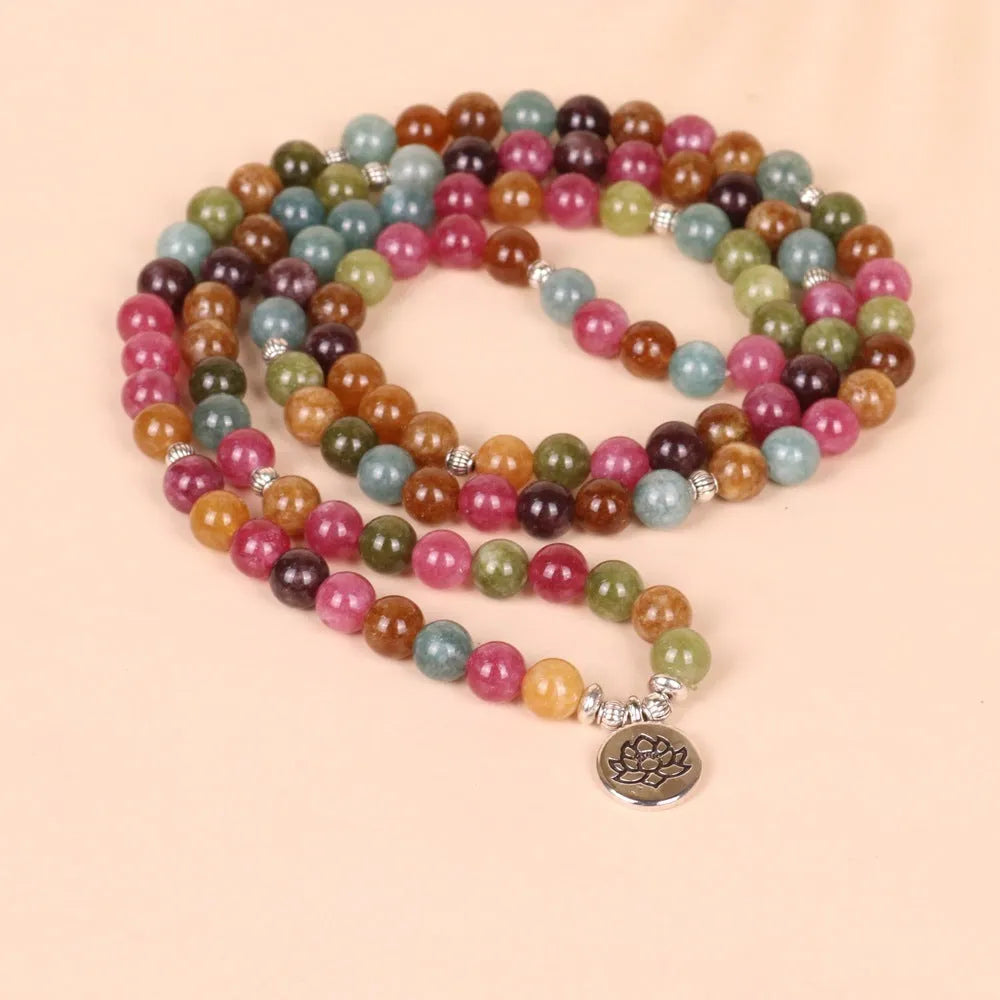 108 bead multi-layer bracelet with lotus charm in tourmaline colour on wrist