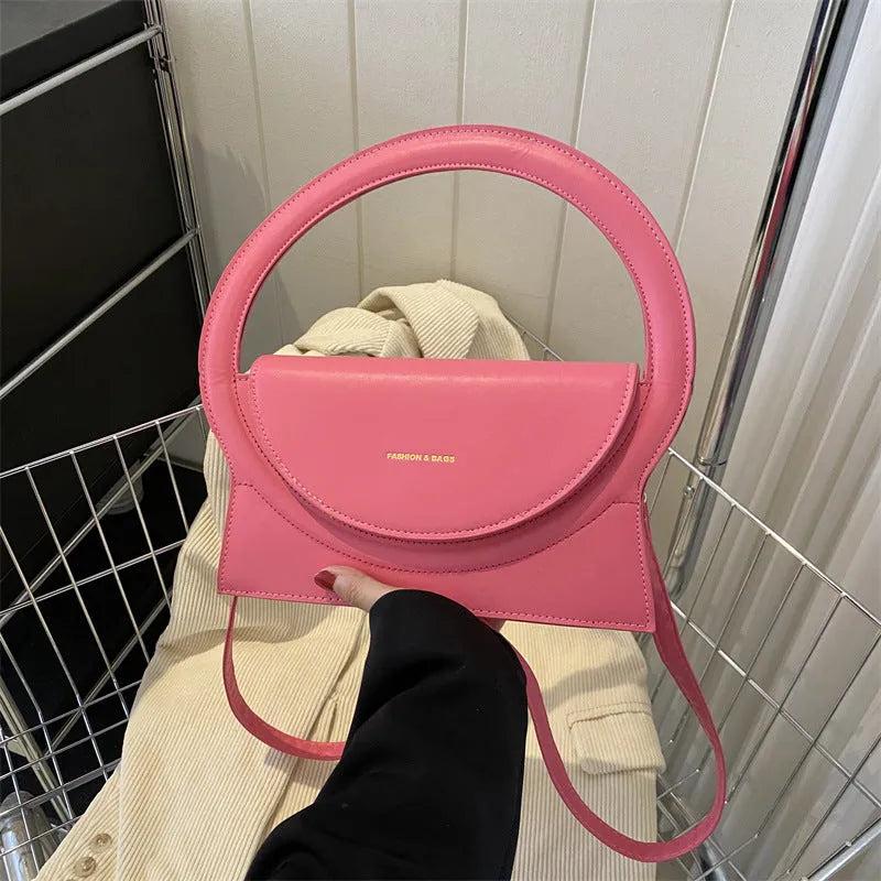 PU messenger bag in a horizontal square shape with a sandwich pocket and stitching detail.