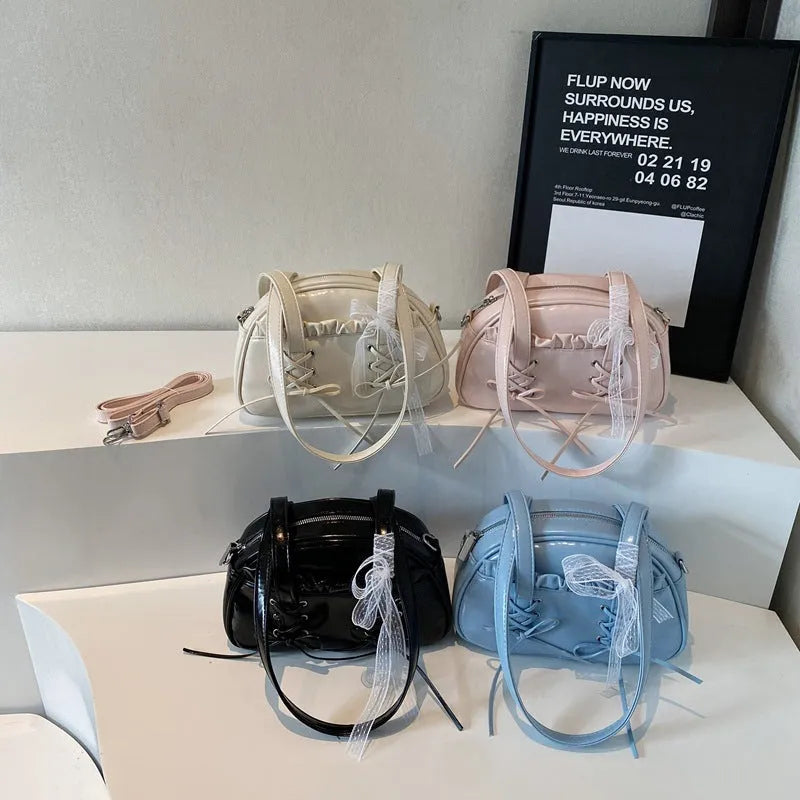 PU leather ladies shoulder handbag with phone compartment in milky white colour showing decorative stitching