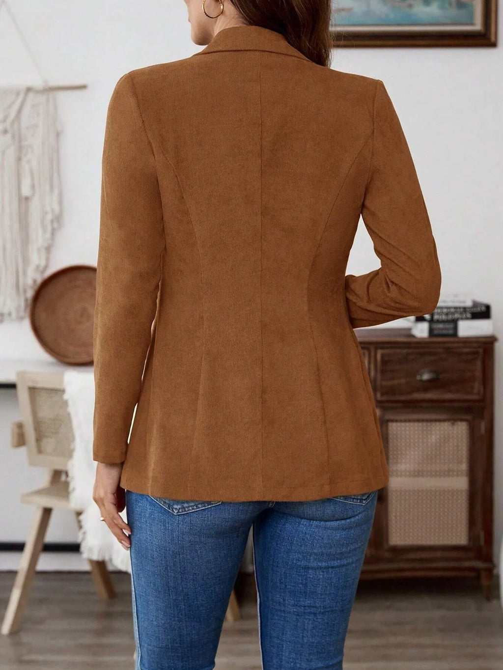 Brown single-breasted leisure suit coat with a lapel collar on a hanger.