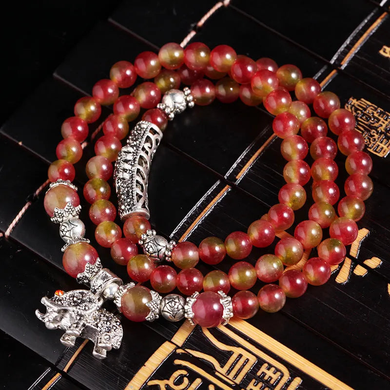 Natural watermelon crystal bracelet with Chinese knot fastening showing bi-colour gemstone beads
