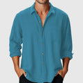A man's loose-fit casual shirt with a stand collar and long sleeves, made from polyester, shown in a colour suitable for beachwear.