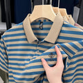 Man wearing a red striped short sleeve casual shirt with a mosaic pattern detail
