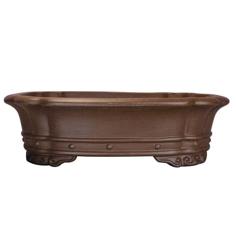 Purple clay handmade rectangular begonia flower pot on a desktop.