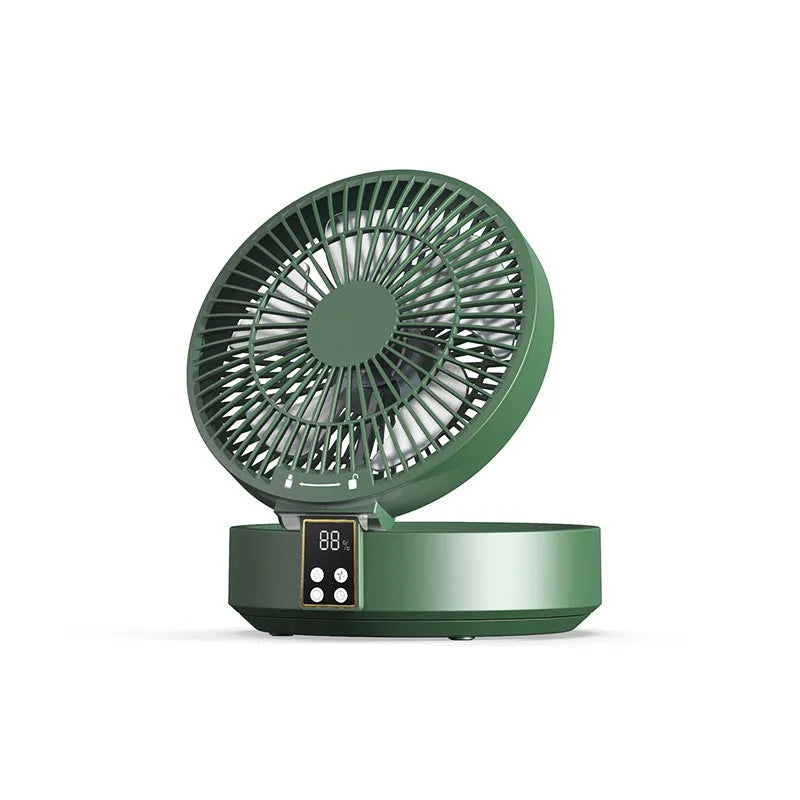 White portable USB folding desk fan with remote control and warm night light on a table.