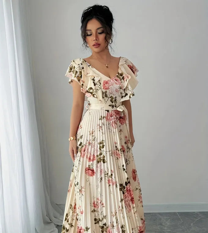 Apricot coloured floral print dress with a v-neck, ruffled short sleeves, and a long high-waisted swing skirt.