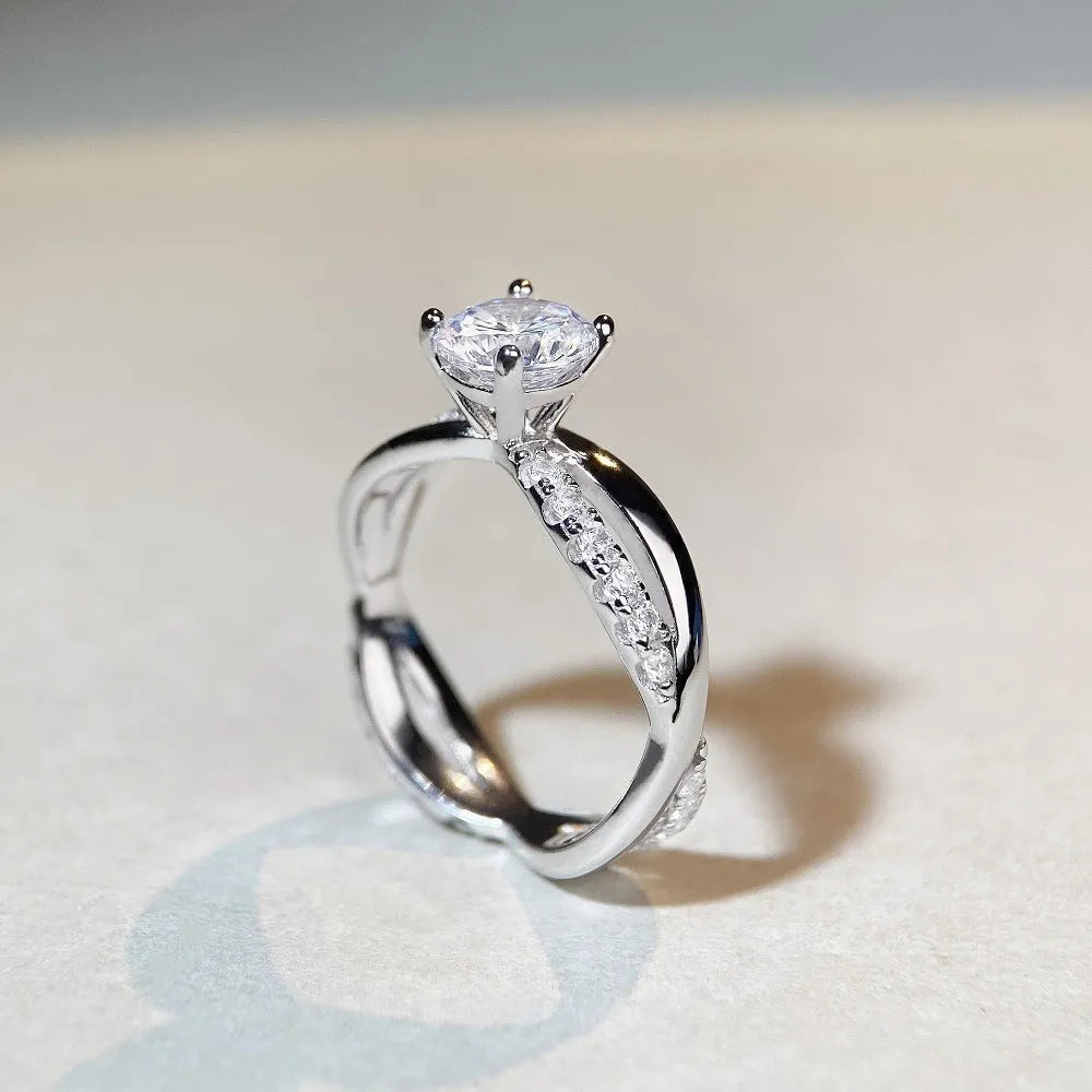Geometric cross pattern silver ring with 1 karat moissanite stone in twisted arm setting
