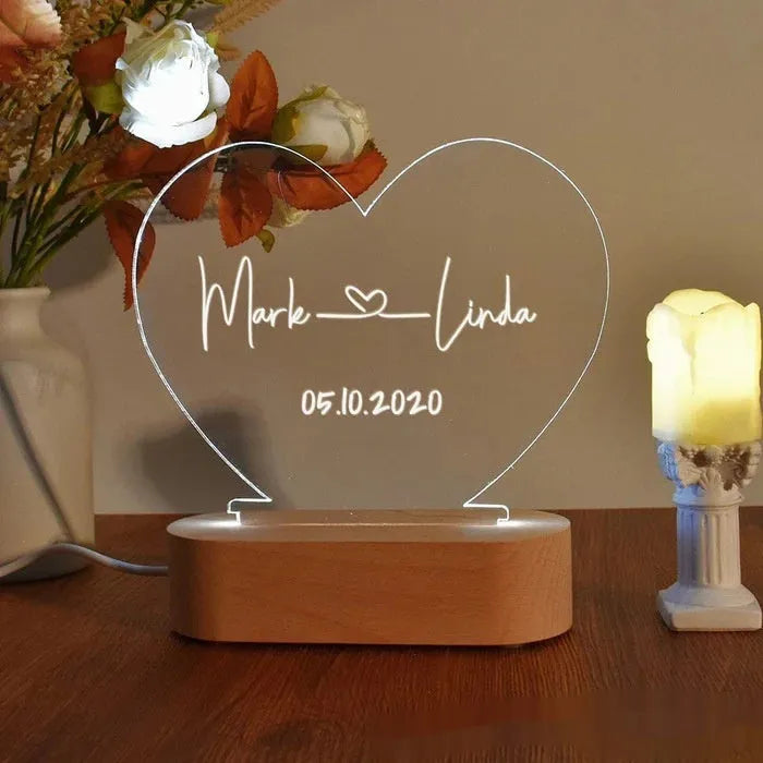 Personalised acrylic LED night light showing custom names and dates with transparent 20x11.5cm design