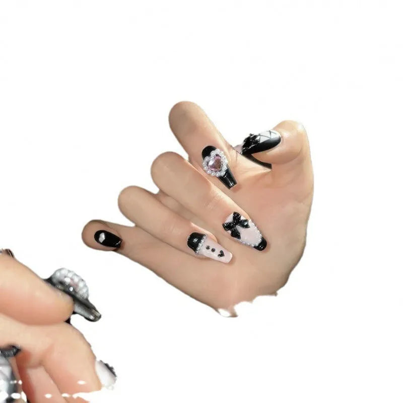 Black and pink heart design hand-painted manicure nails with cat's eye styling