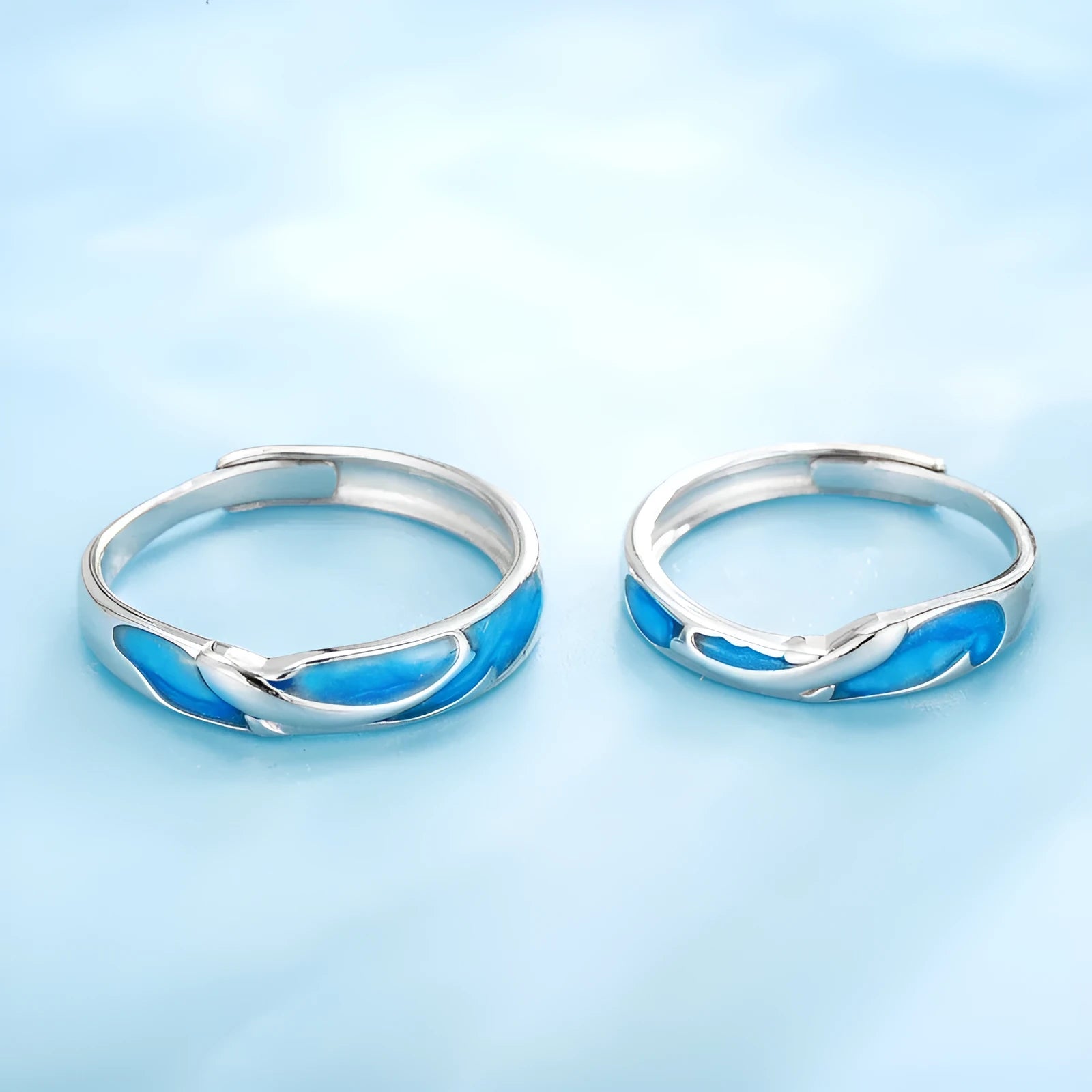 Silver adjustable couple ring with dolphin zodiac motif on white background