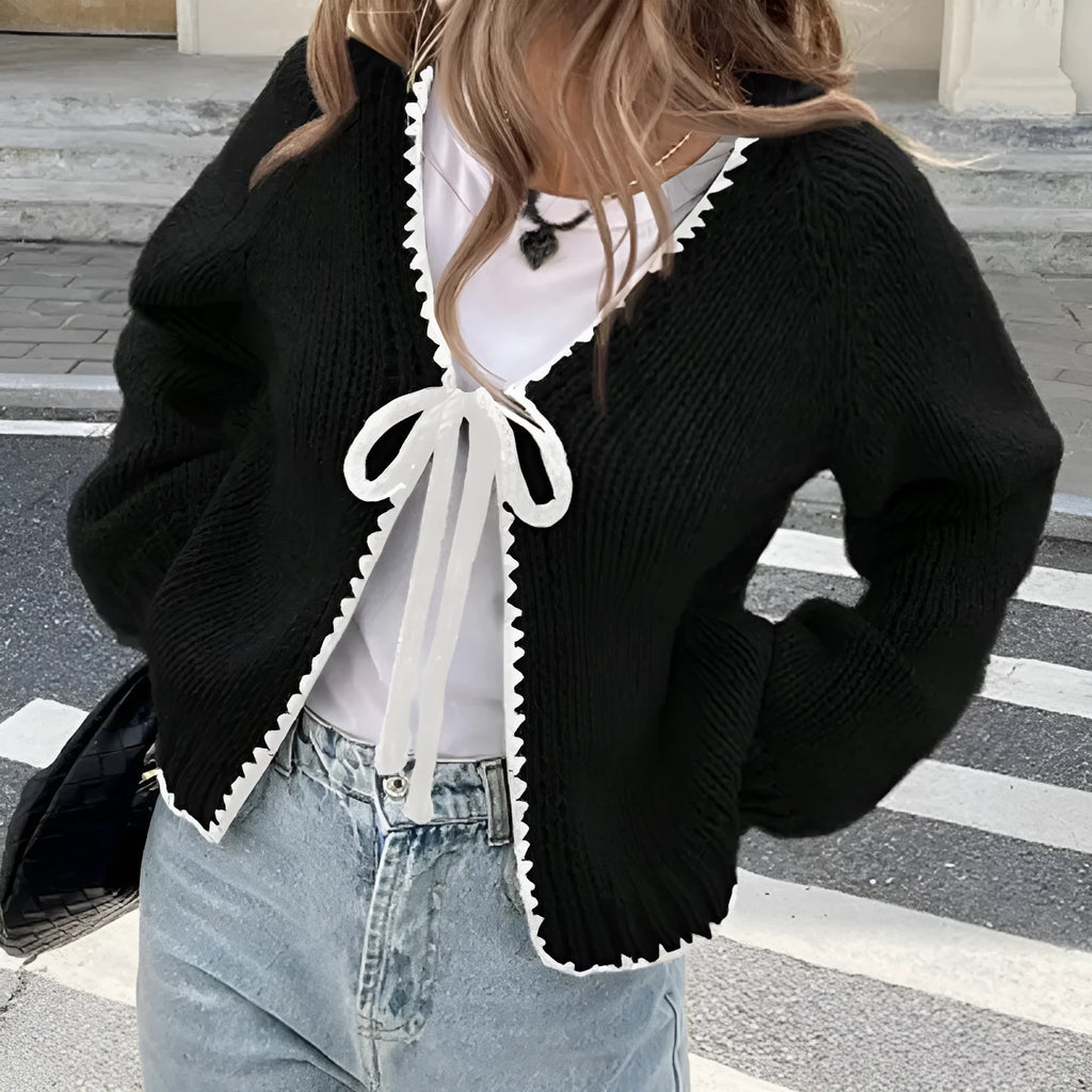 Grey lace-up sweater cardigan with long sleeves and crocheted flower decoration on the front.