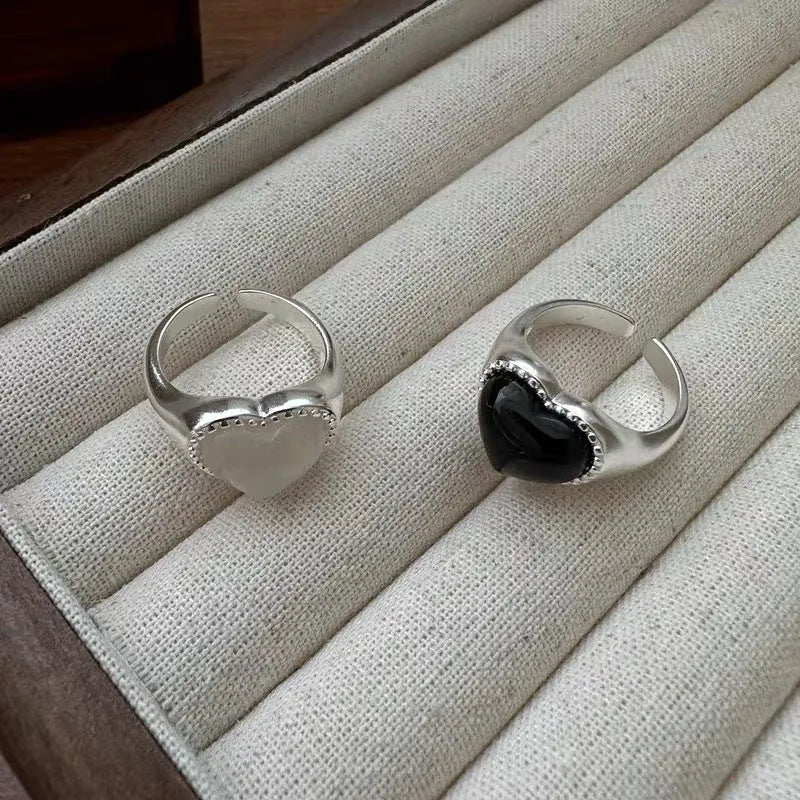 S925 sterling silver ring with black agate heart on adjustable open band.