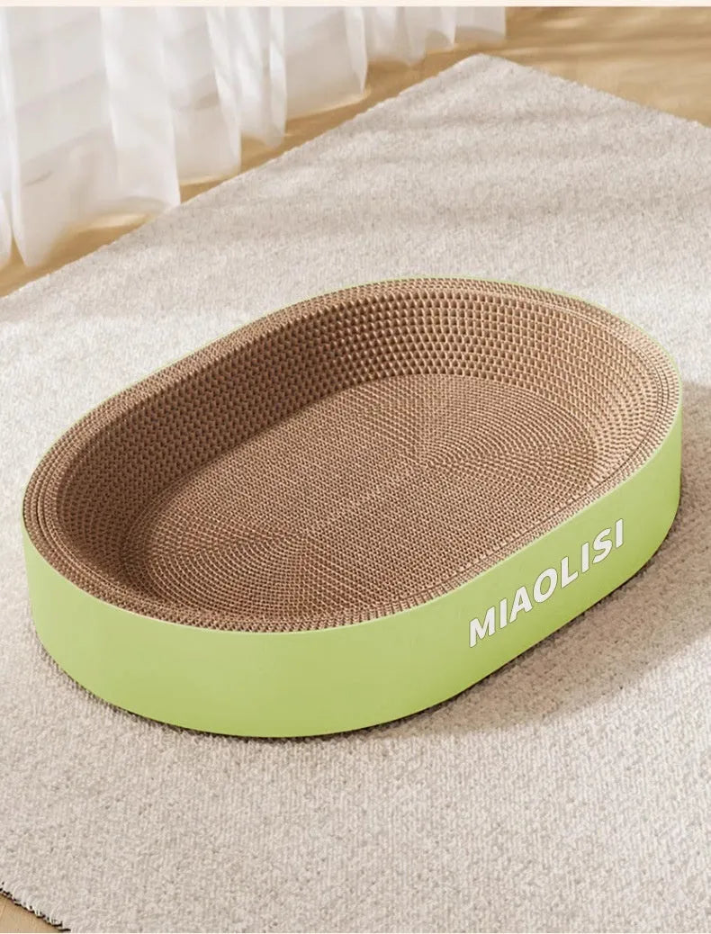 Large green oval corrugated paper cat scratch board serving as a nest for a cat.