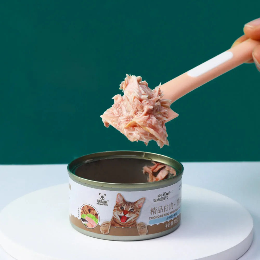 Green long-handled pet food spoon with right-angle head for scraping canned wet food.