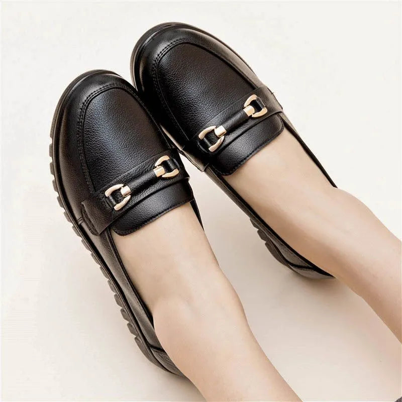 Black women's round-toe pumps with a low flat heel and elastic slip-on design.