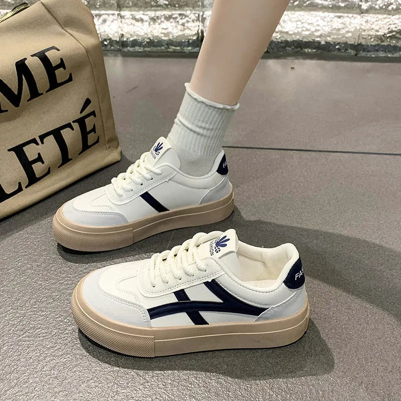 Brown and blue low-top lace-up casual shoes with a patent leather finish and round toe.