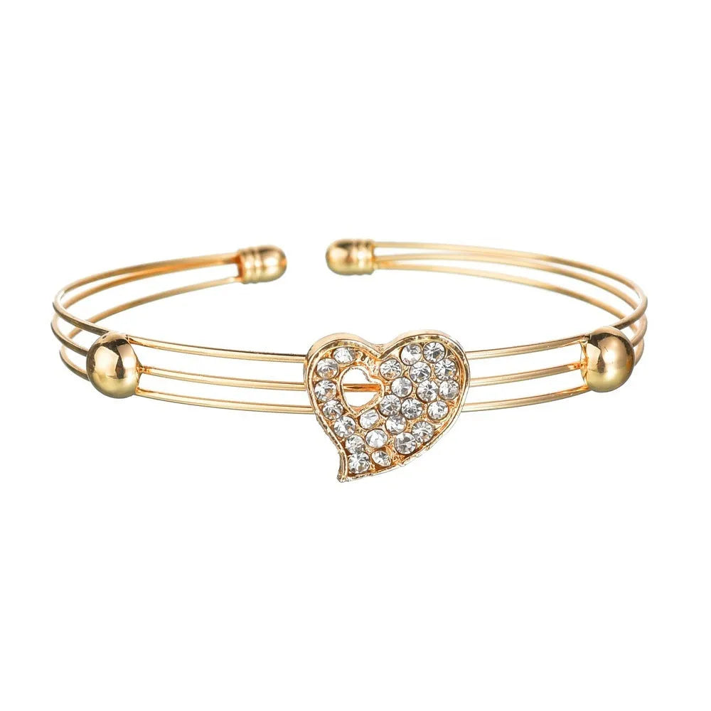 Gold-plated alloy women's jewellery set with earrings, necklace, and bracelet featuring love, water drop, and bell pendants.