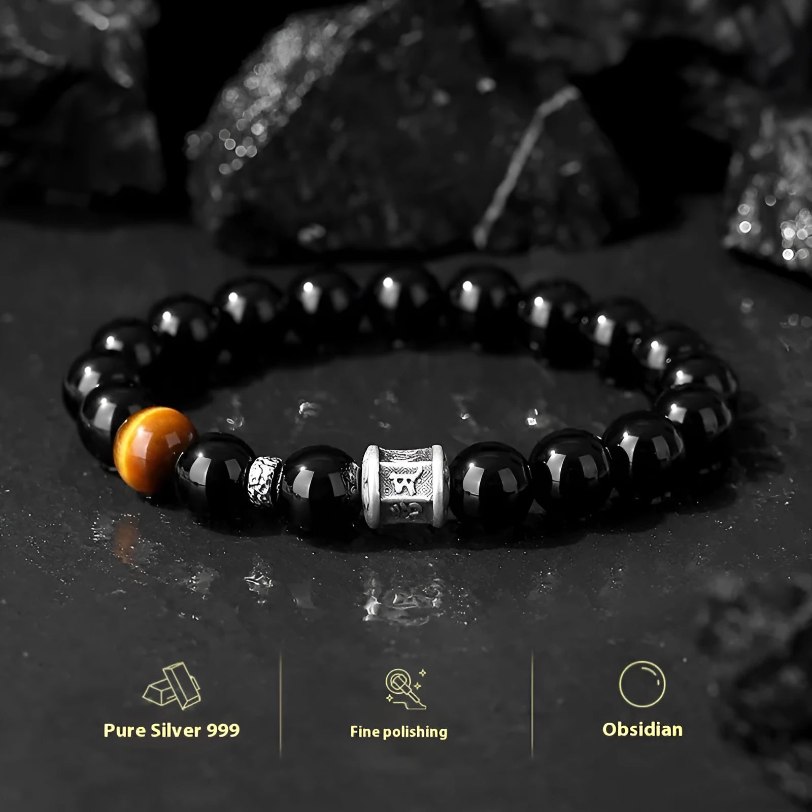 Mens black obsidian bracelet with silver prayer wheel charm on wrist