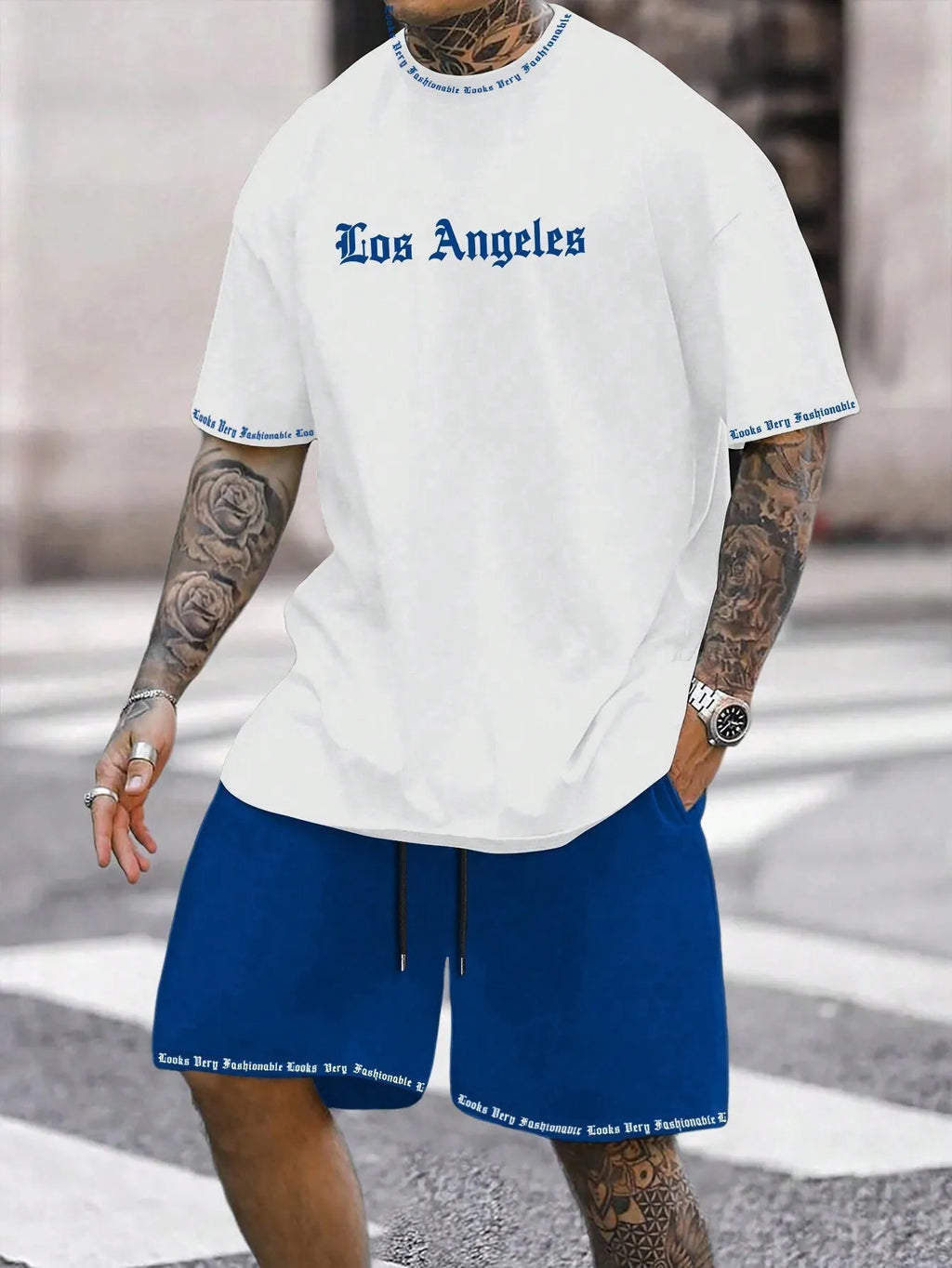 Men's blue printed short-sleeve top and matching shorts sports suit on a hanger.