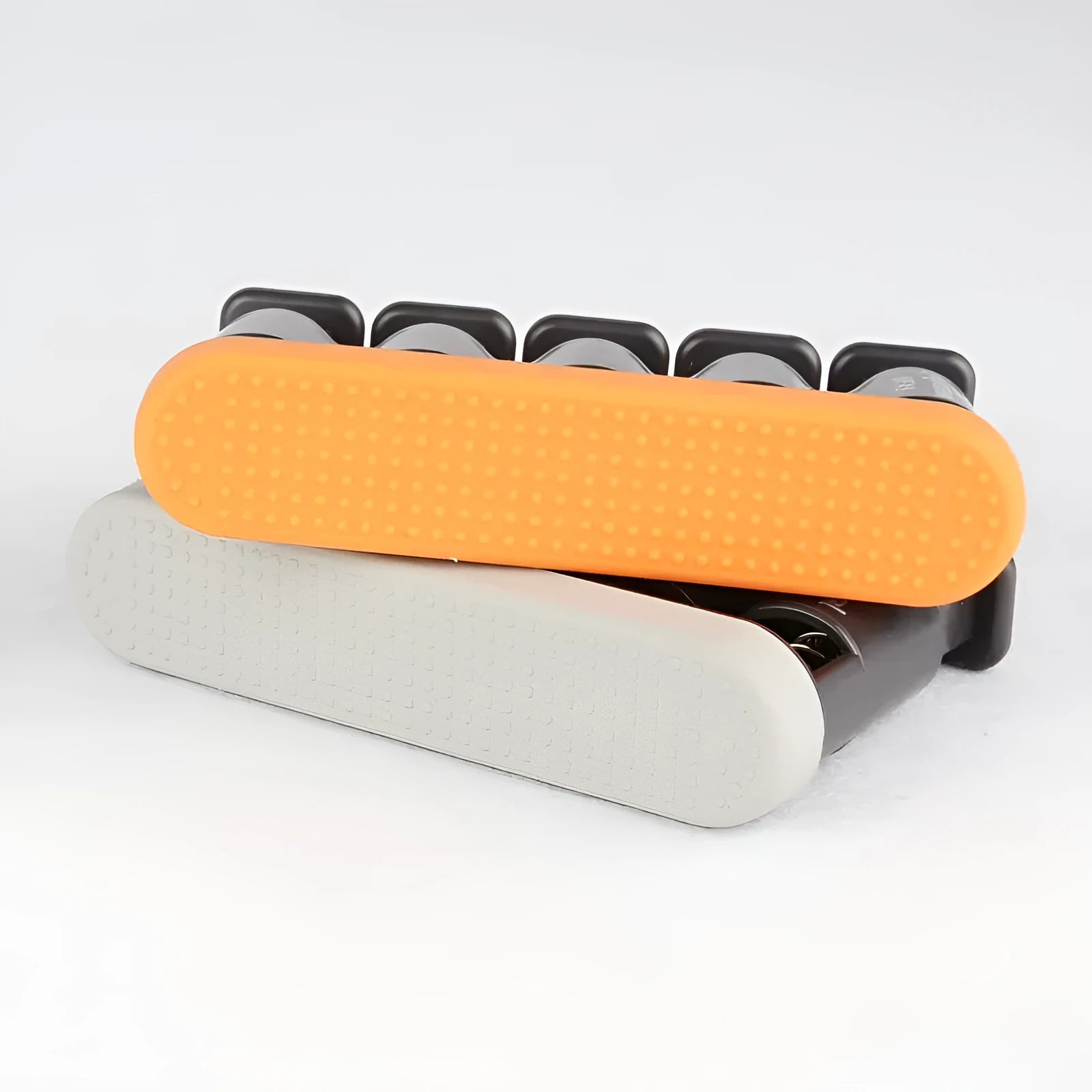 Grey and orange silicone finger strength trainer for musicians and climbers.
