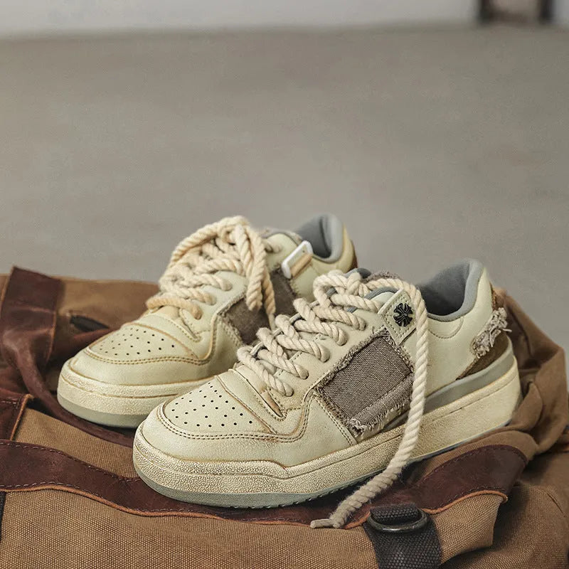 Beige low-top vintage skate shoes with lace-up front and rubber sole.