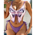 Women's purple bikini swimsuit with bow detail and split-style briefs on a mannequin.
