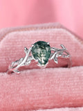 S925 silver drop-shaped agate edge branch leaf ring on white background, sterling silver band with natural stone