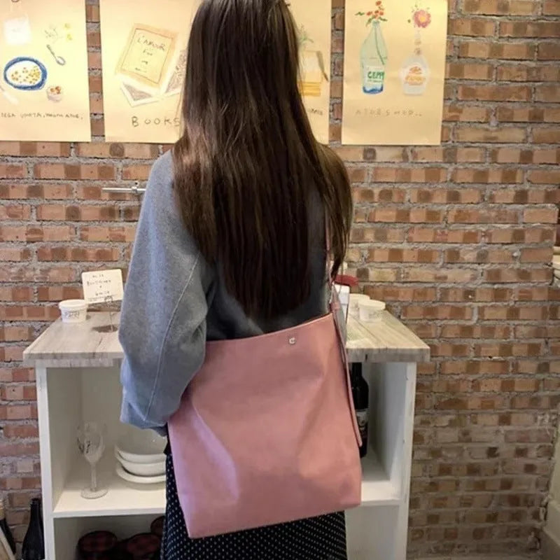 Pink or brown corduroy one-shoulder commuter bag showing dimensions