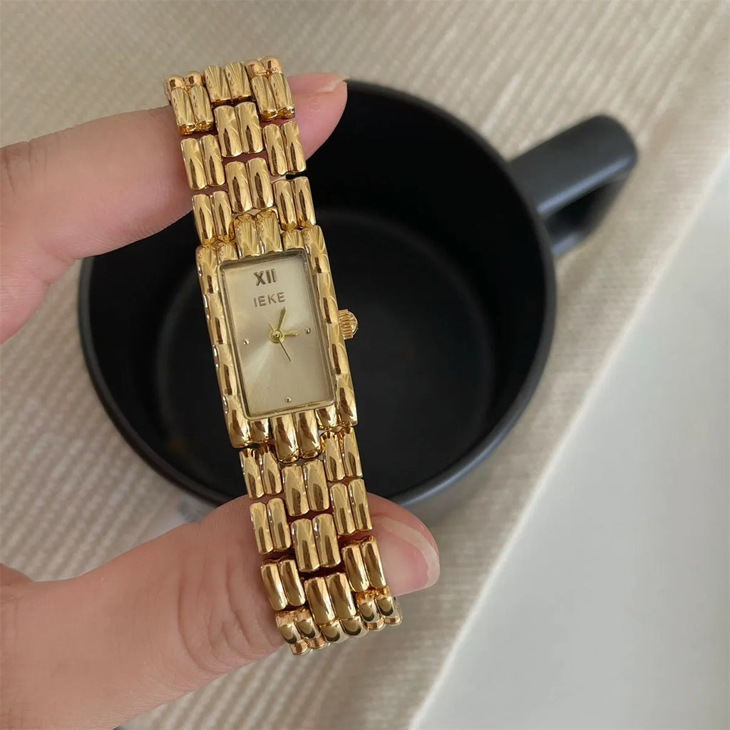 Women's mid-century bracelet watch with 15mm dial, mineral glass, and butterfly buckle in gold or silver options