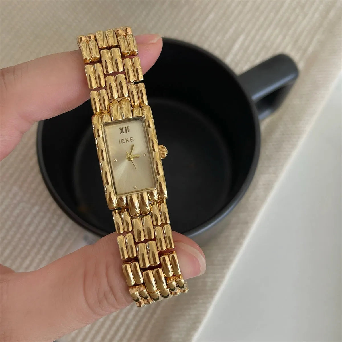 Women's mid-century bracelet watch with 15mm dial, mineral glass, and butterfly buckle in gold or silver options